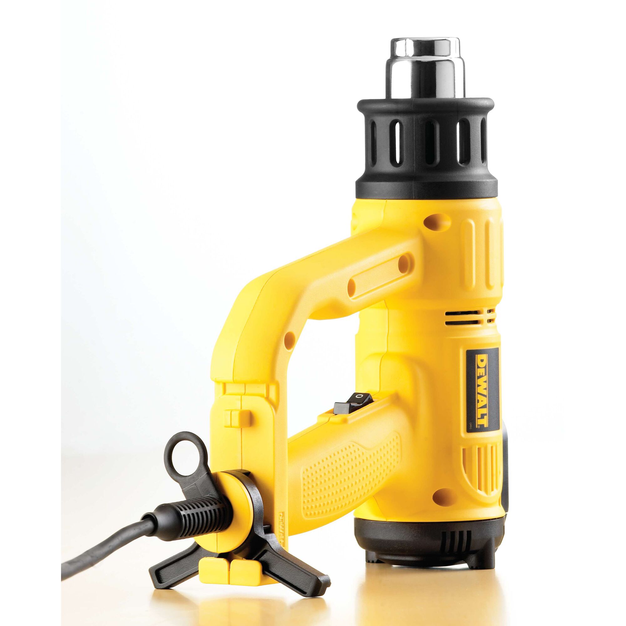DEWALT D26414 yellow heat gun tool with a black nozzle and cord, placed on a light surface.