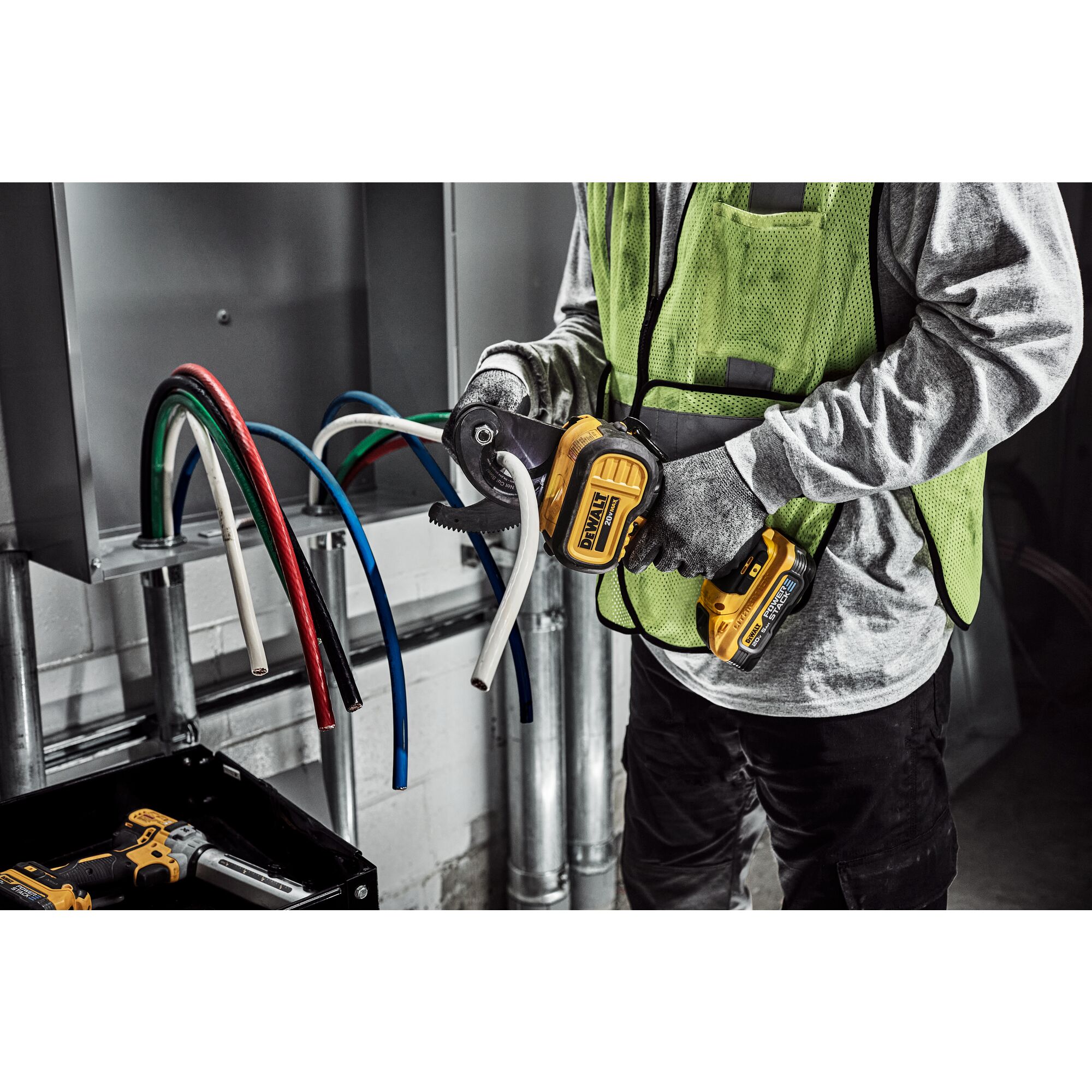 DEWALT Cable Cutter is used to cute cable to length by a tradesman in a electrical room.