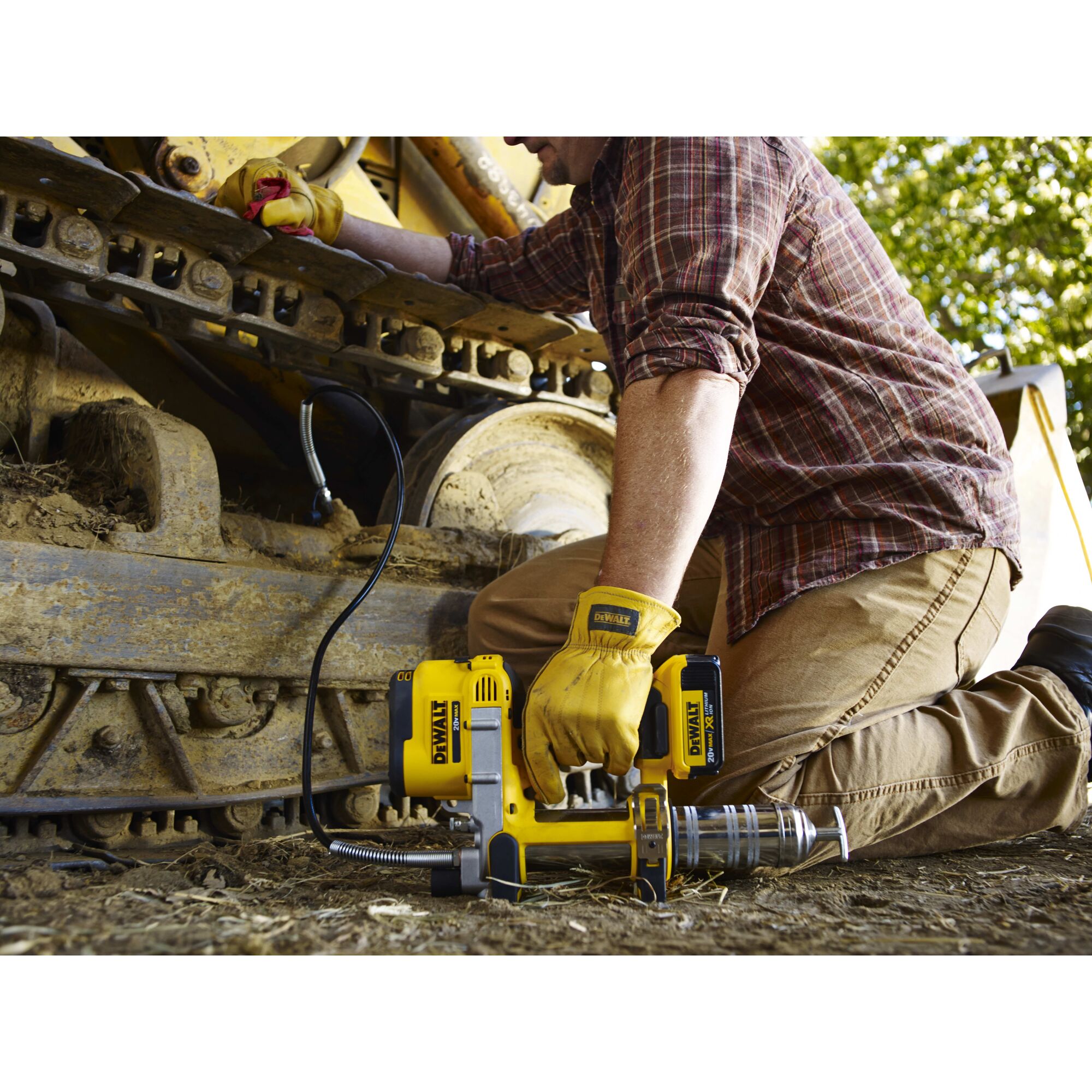 Grease gun being held by person outdoors