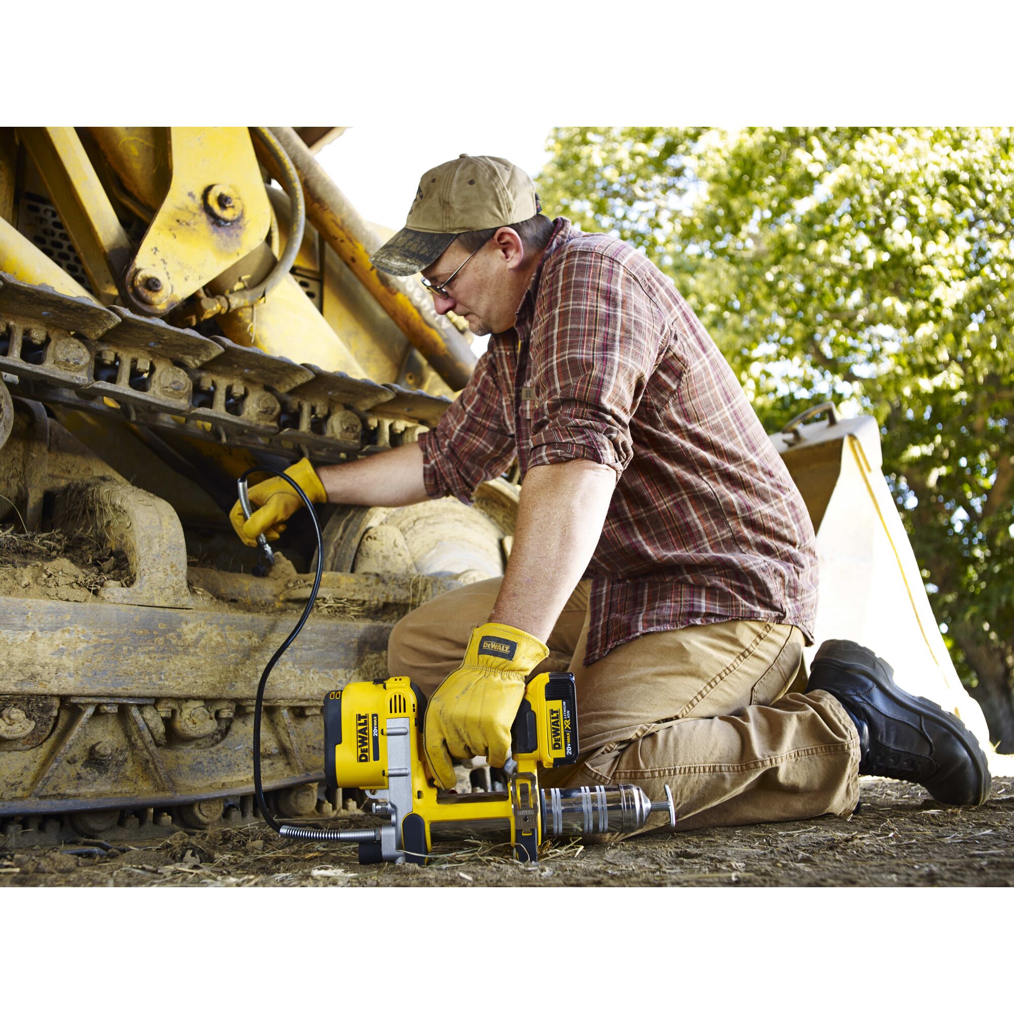 Grease gun being used by a person outdoors