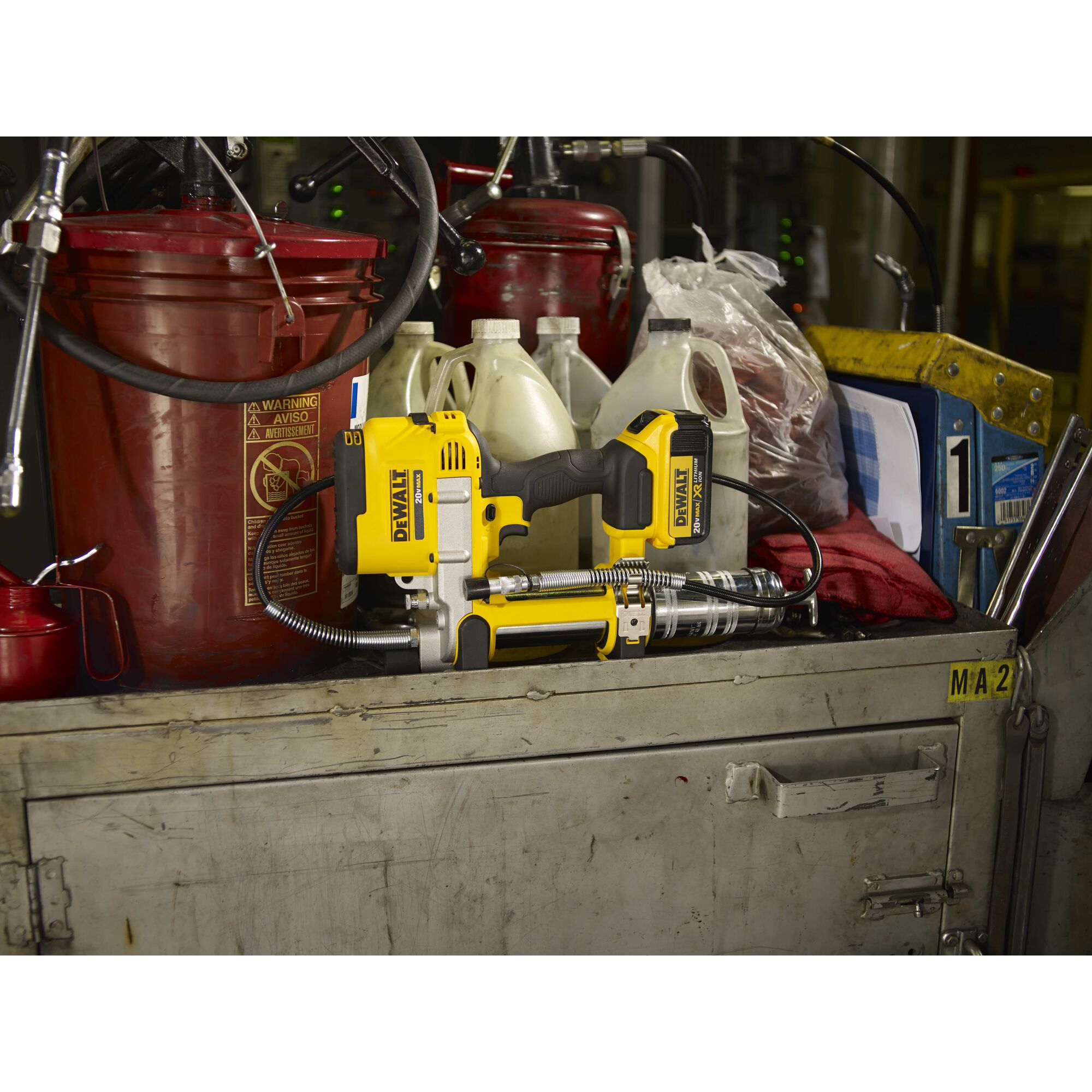 Grease gun being placed on shelf