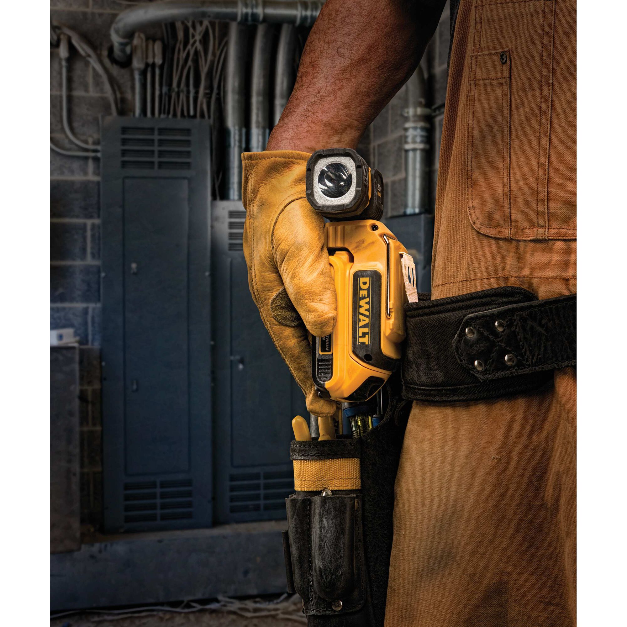 LED hand held worklight being shown in a person's tool pouch