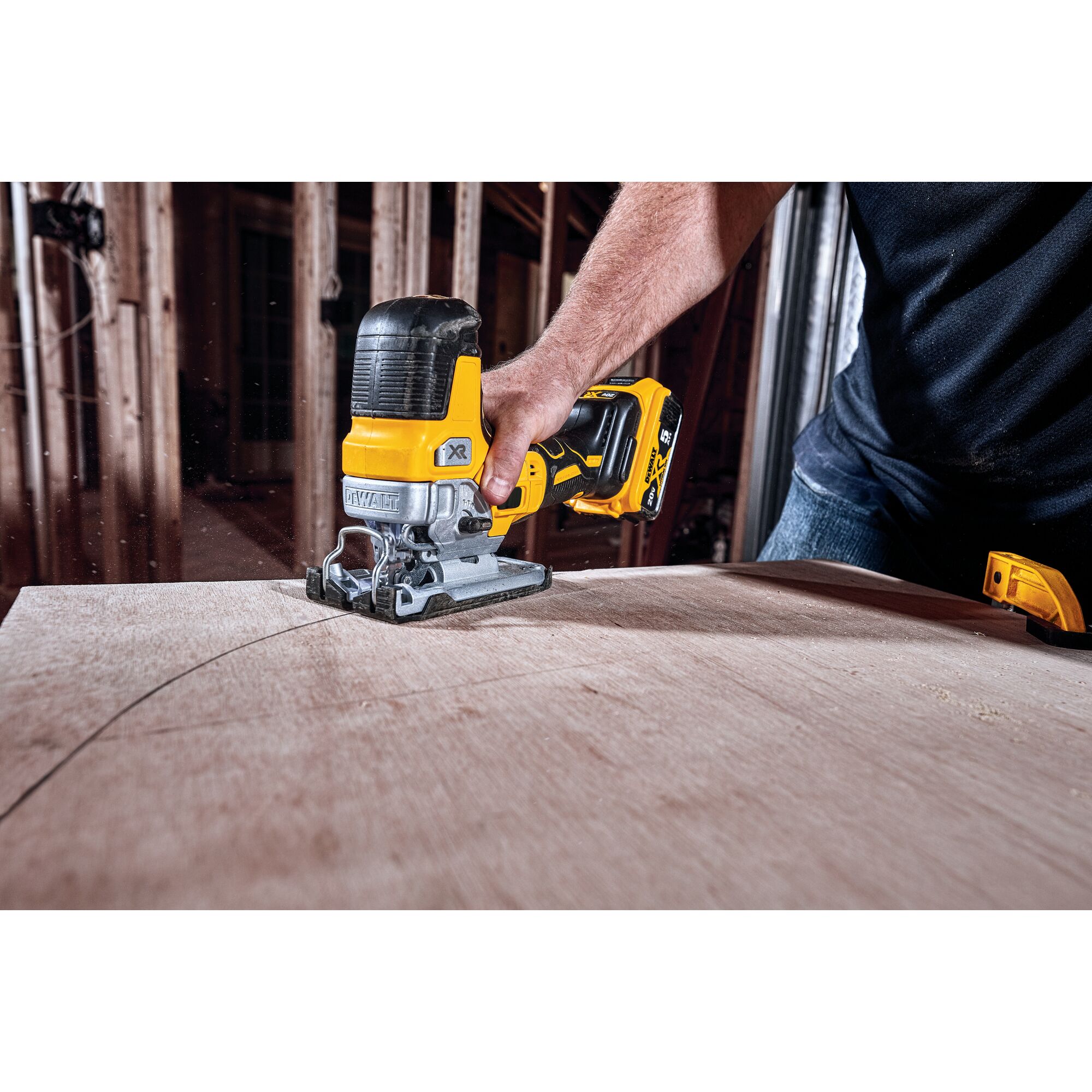 XR Cordless Barrel Grip Jig Saw being used by person to cut curved lines in wooden surface.