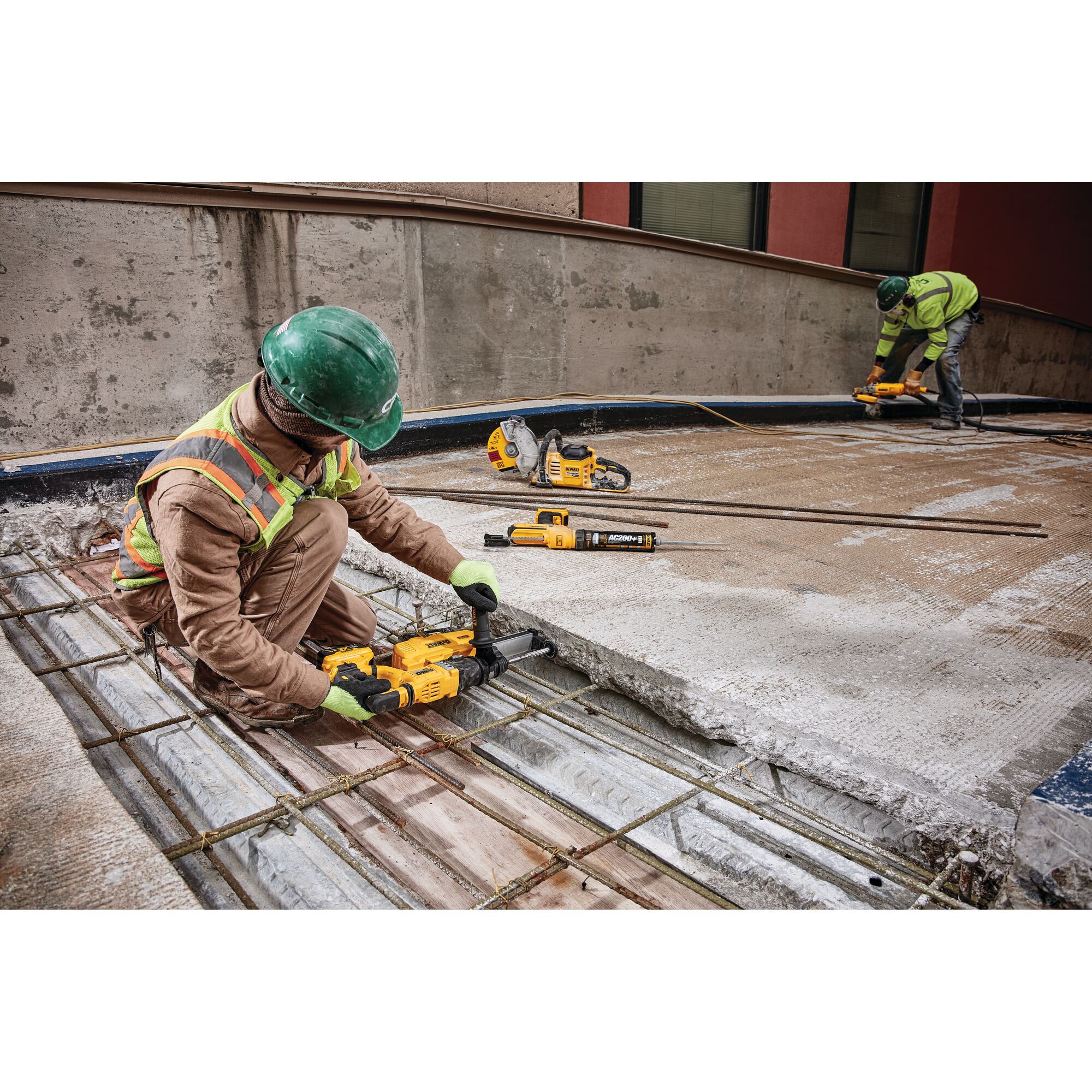 Dust extractor being used by a person to drill.